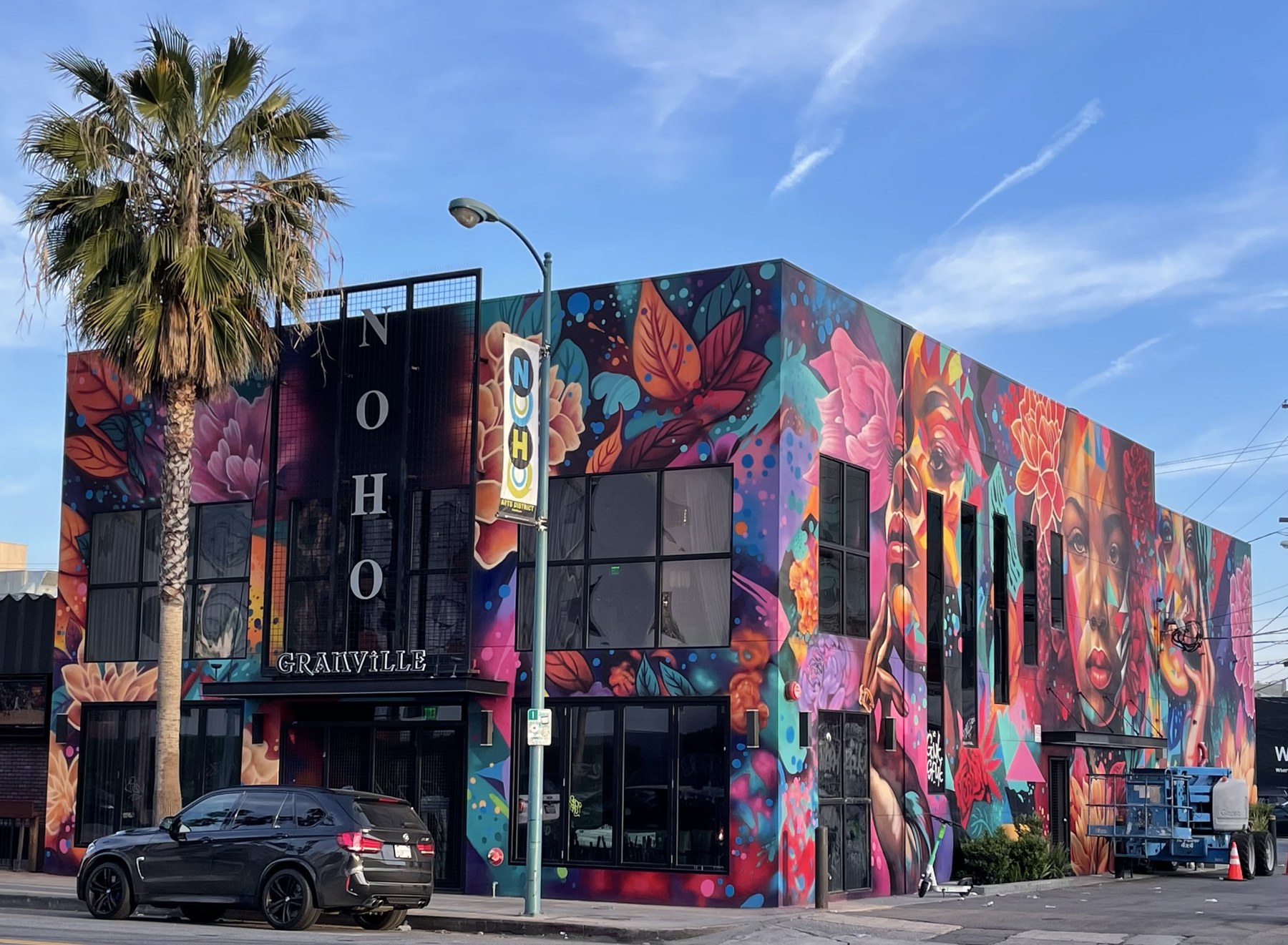 The Granville restaurant building in North Hollywood, fully muraled by Shane Grammer, with the NoHo sign visible